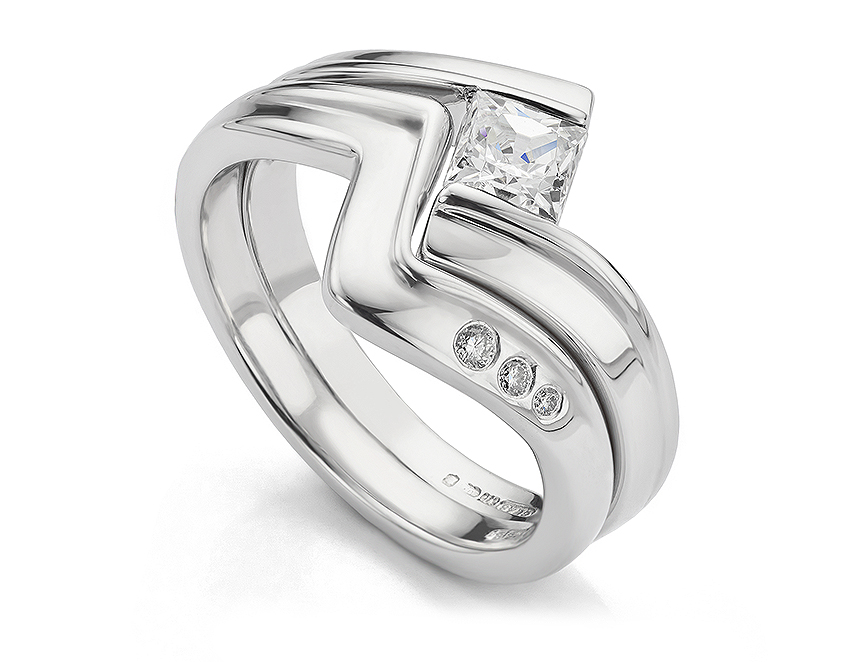 Z shaped wedding ring. A Z shaped diamond wedding ring flush set with three graduating diamonds. 