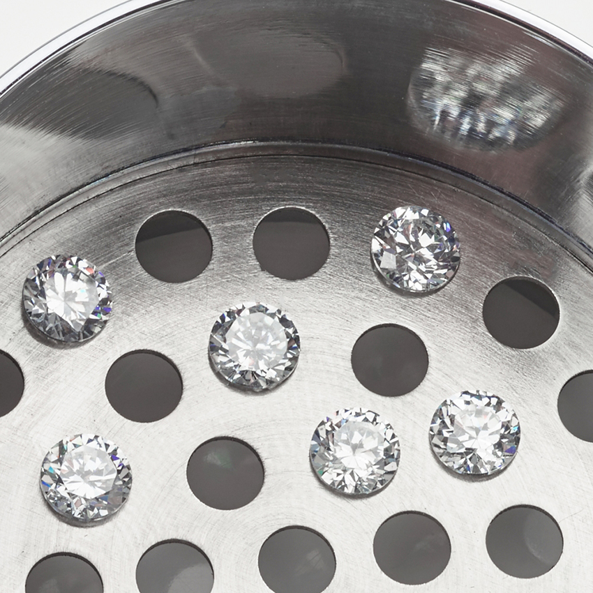 Loose natural diamonds in sieve
