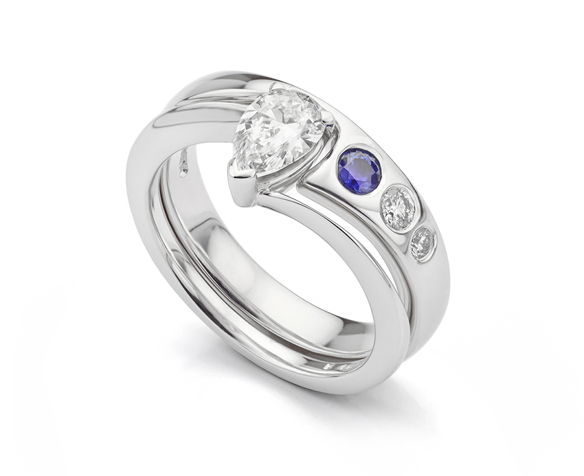 Shaped wedding ring with a combination of diamonds and flush set Sapphire