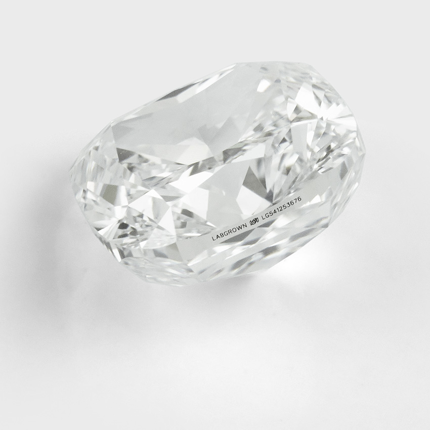Lab grown cushion cut diamond with visible labgrown inscription on the diamond's girdle.