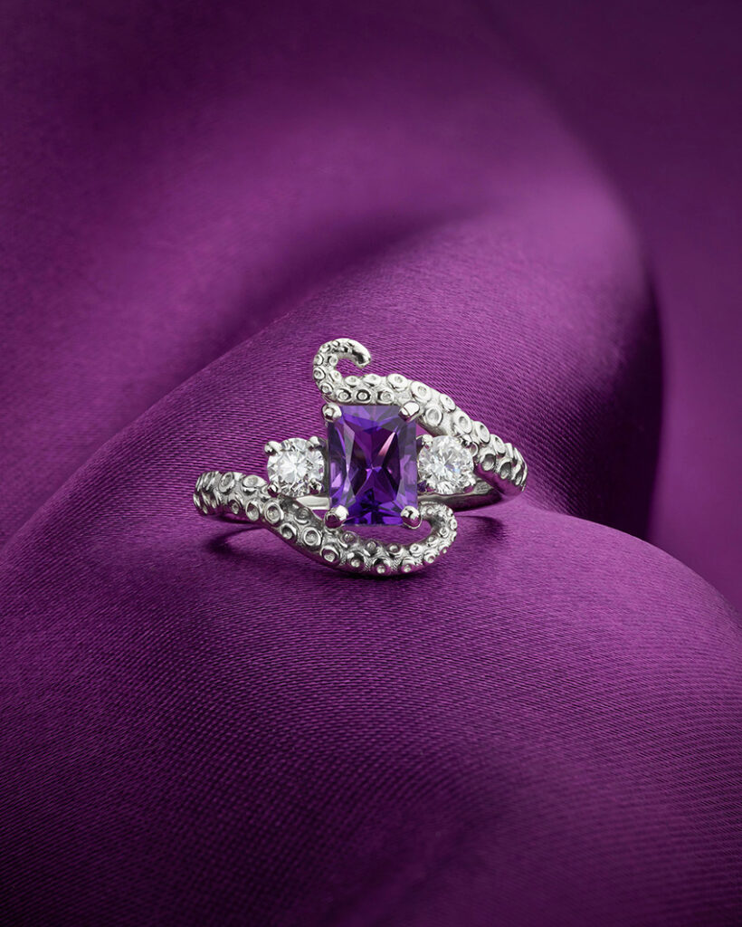 February's birthstone Amethyst radiates from the centre of the octopus engagement ring