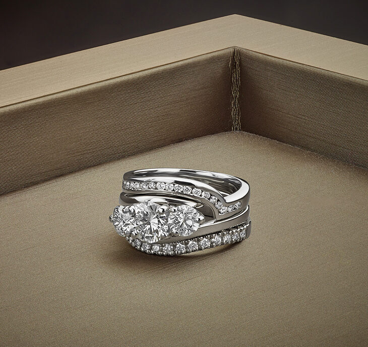Unconventional engagement ring shown with matching wedding and eternity ring