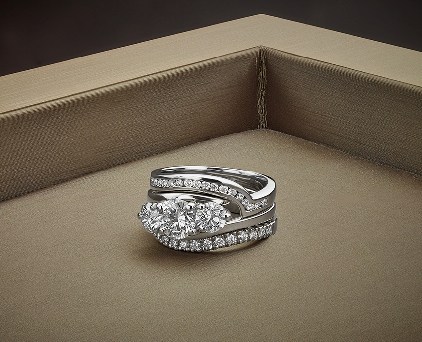 Unconventional engagement ring shown with matching wedding and eternity ring