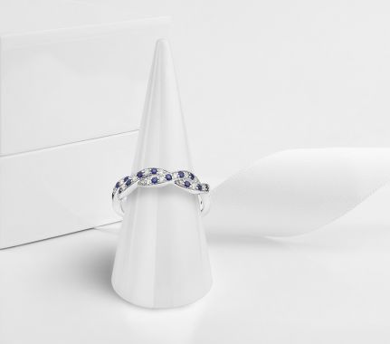 Blue sapphire wedding ring on display cone