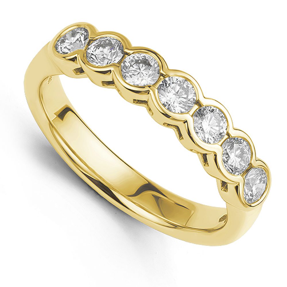 Bezel set half diamond eternity ring in yellow gold