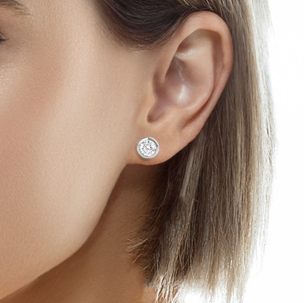 Rubover diamond earrings shown in ear