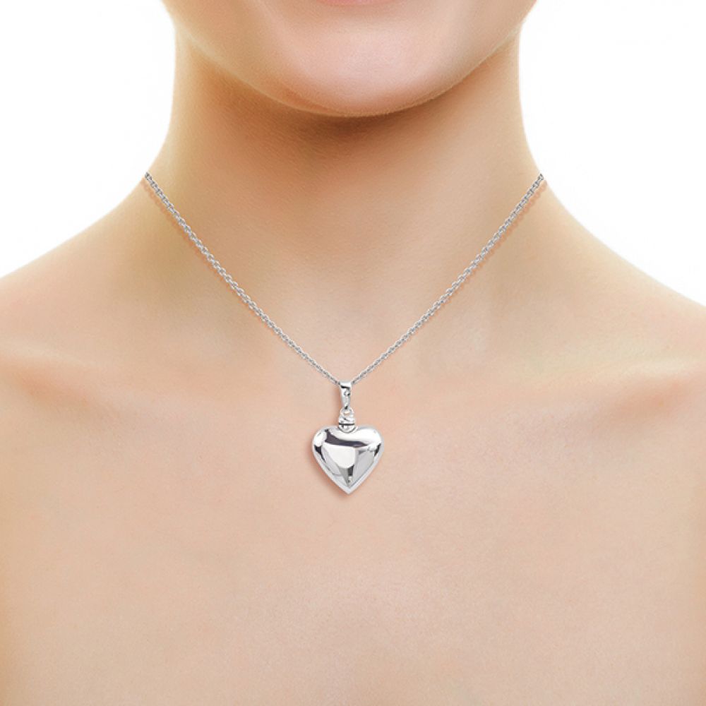 Silver heart keepsake necklace on neck.