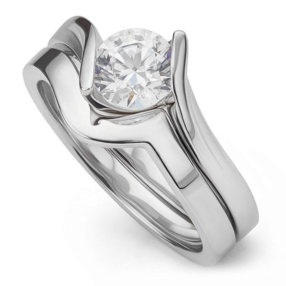 Unity shaped wedding ring shown with engagement ring