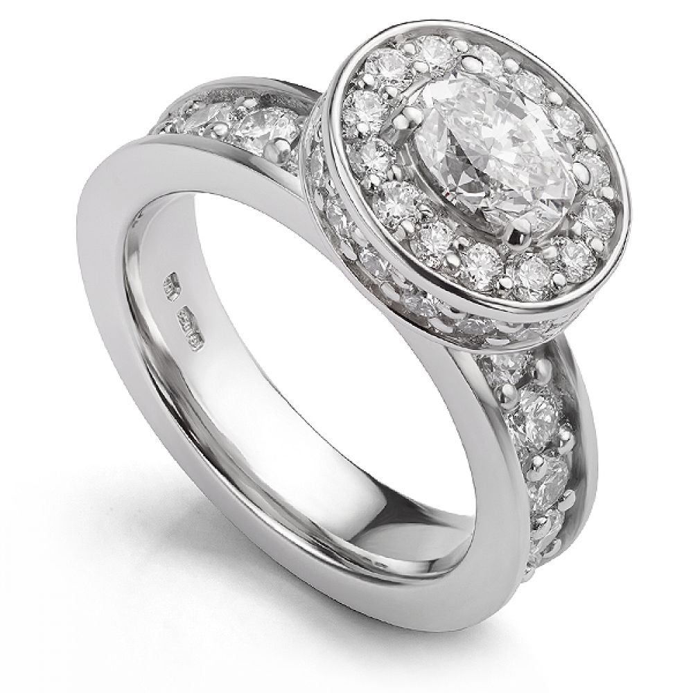 Hidden halo oval engagement ring with diamond shoulders