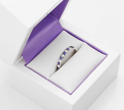 Half diamond eternity ring set with blue sapphires and diamonds