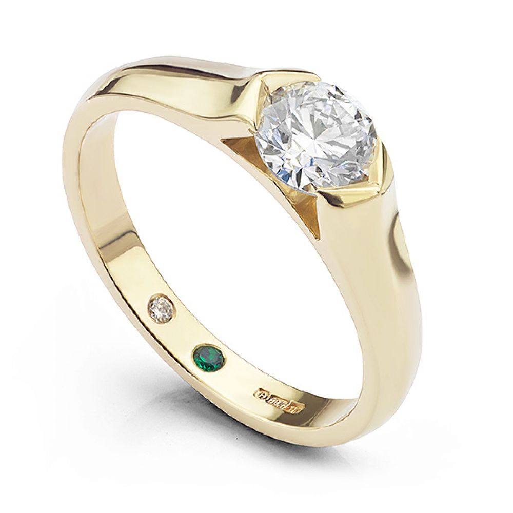 Bespoke tension engagement ring with secret flush-set diamond and emerald