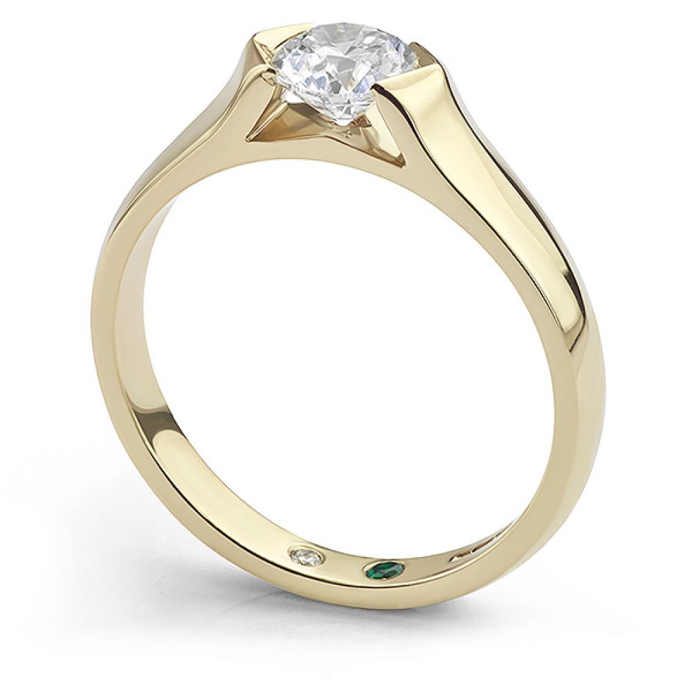 Bespoke tension engagement ring with secret flush-set diamond and emerald side view