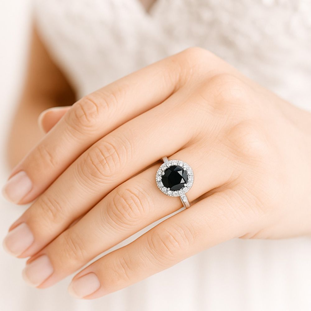 Black and white diamond halo ring on finger Black and white diamond halo ring on finger