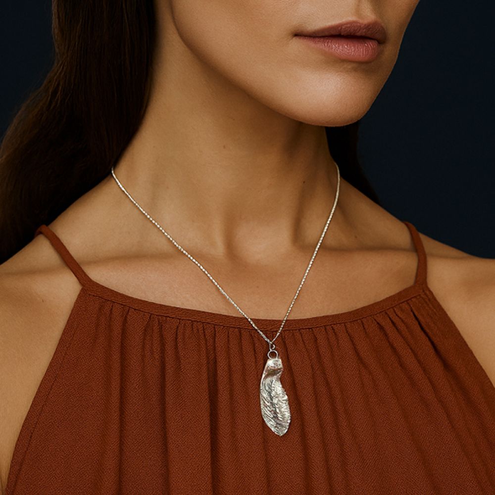 Paper bark maple necklace on Autumnal background worn around neck Paper bark maple necklace on Autumnal background worn around neck