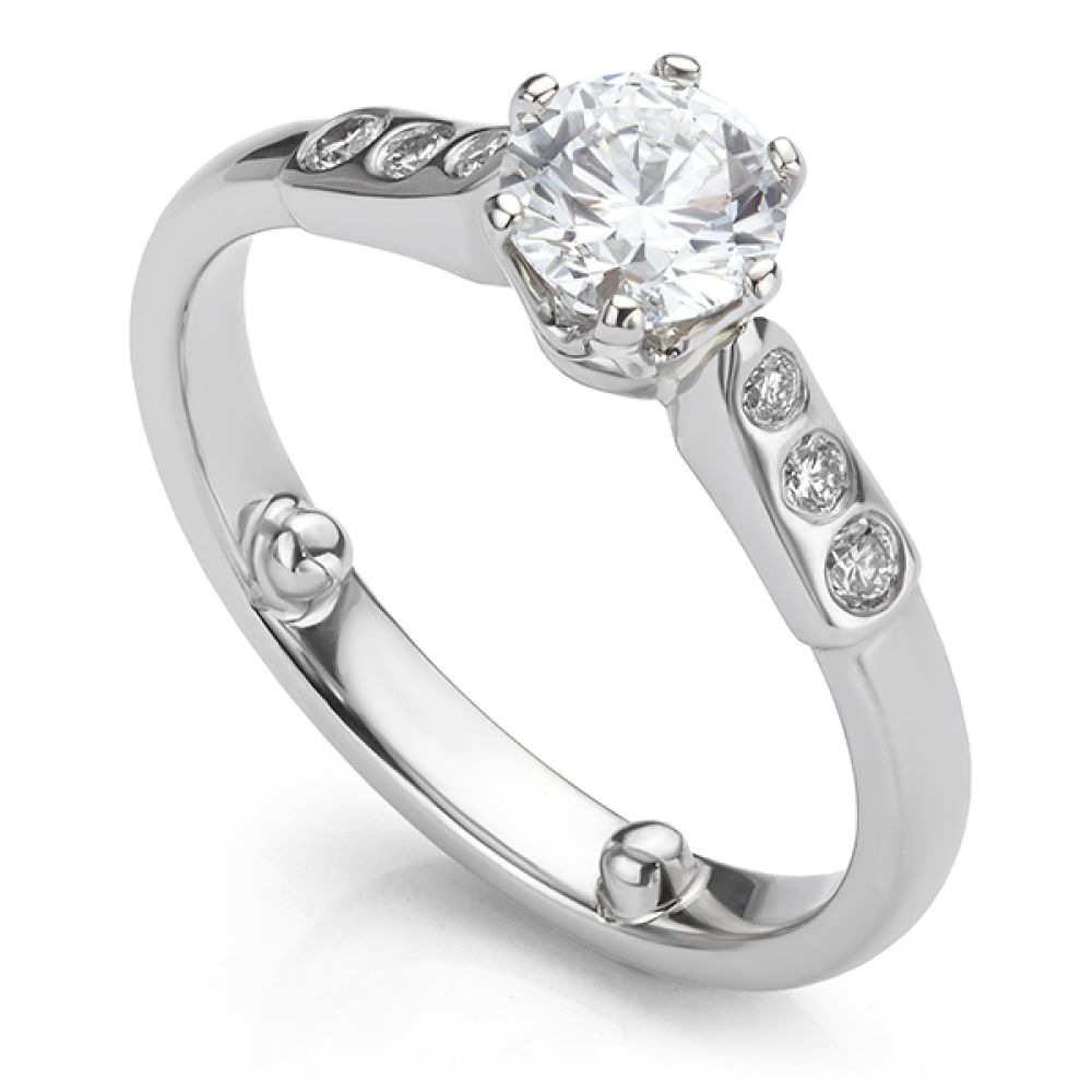 Tiffany style engagement ring with flush-set diamond shoulders