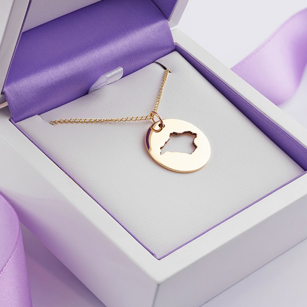 Yellow gold disc shaped Isle of Wight cutout necklace boxed in yellow gold