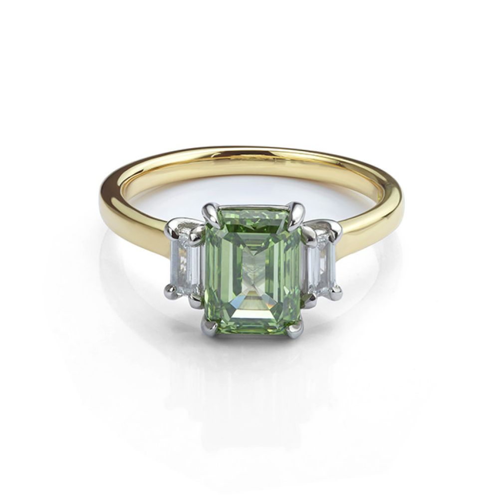 Flat view of the green Emerald cut diamond and baguette cut diamond trilogy ring