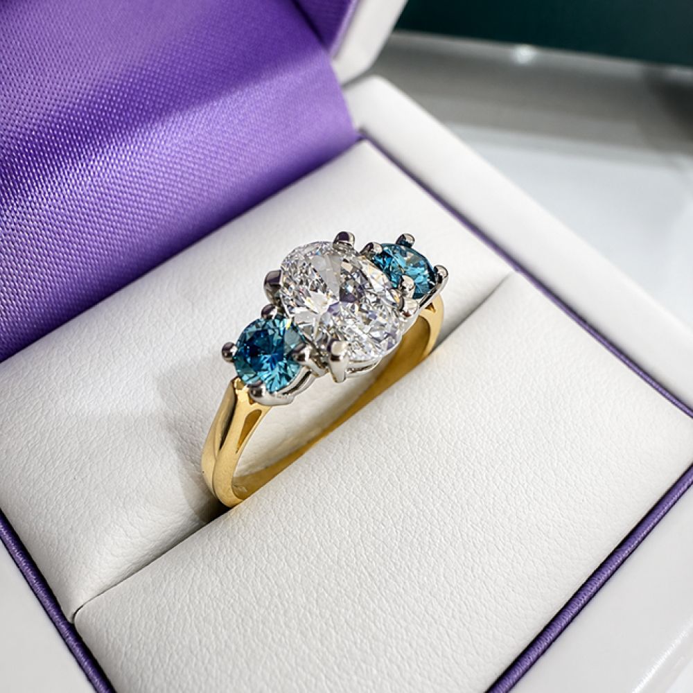 Trilogy Oval and Blue Diamond Engagement Ring in Box