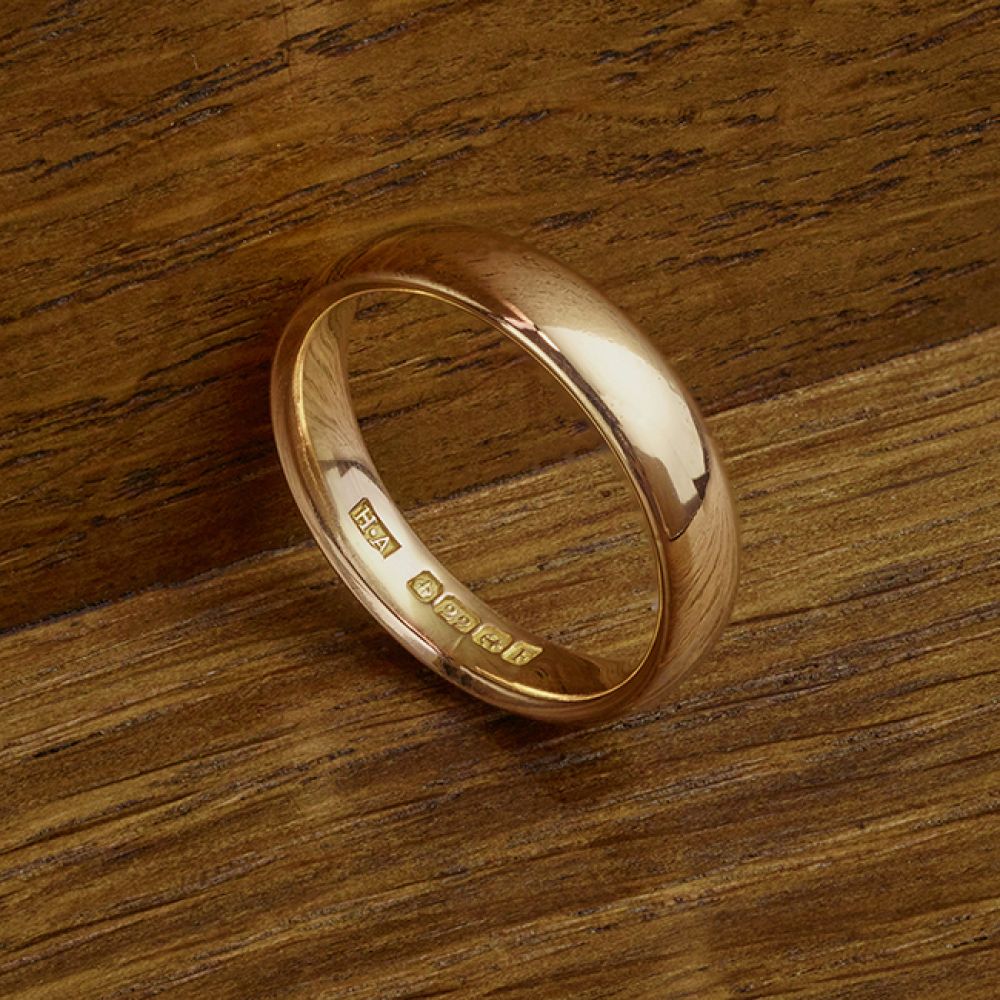 Pre-Loved Vintage 22ct Gold 1930 Wedding Ring on Wood Background