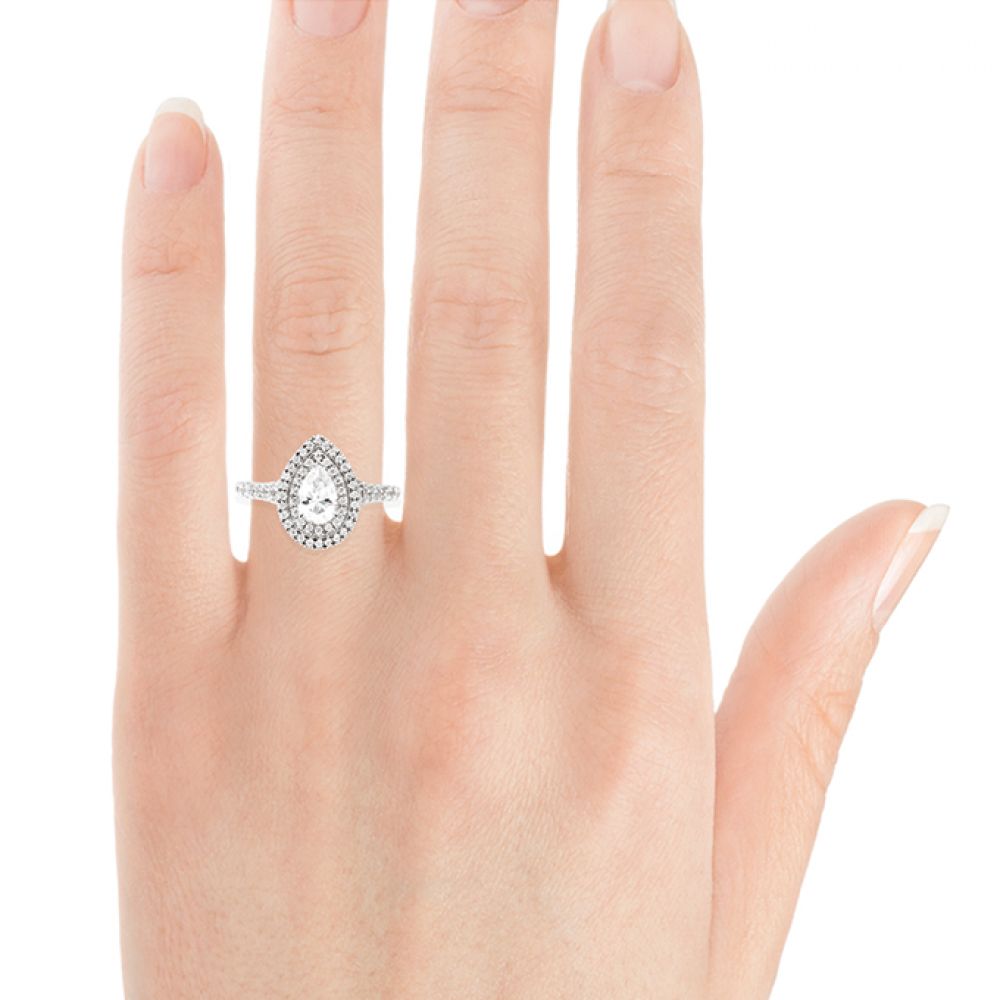 Pear shaped double halo engagement ring on hand Pear shaped double halo engagement ring on hand