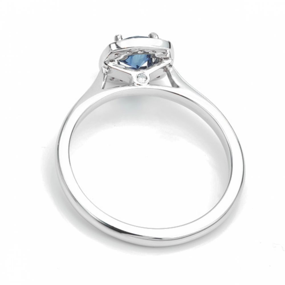 Royal blue sapphire and diamond cushion halo engagement ring side view