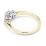 Oval and round diamond three stone ring side view yellow gold Oval and round diamond three stone ring side view yellow gold