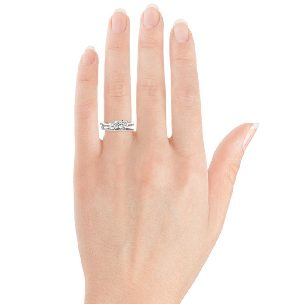 Showing a plain wedding ring sat with the 1 carat version of the Princess cut trilogy ring